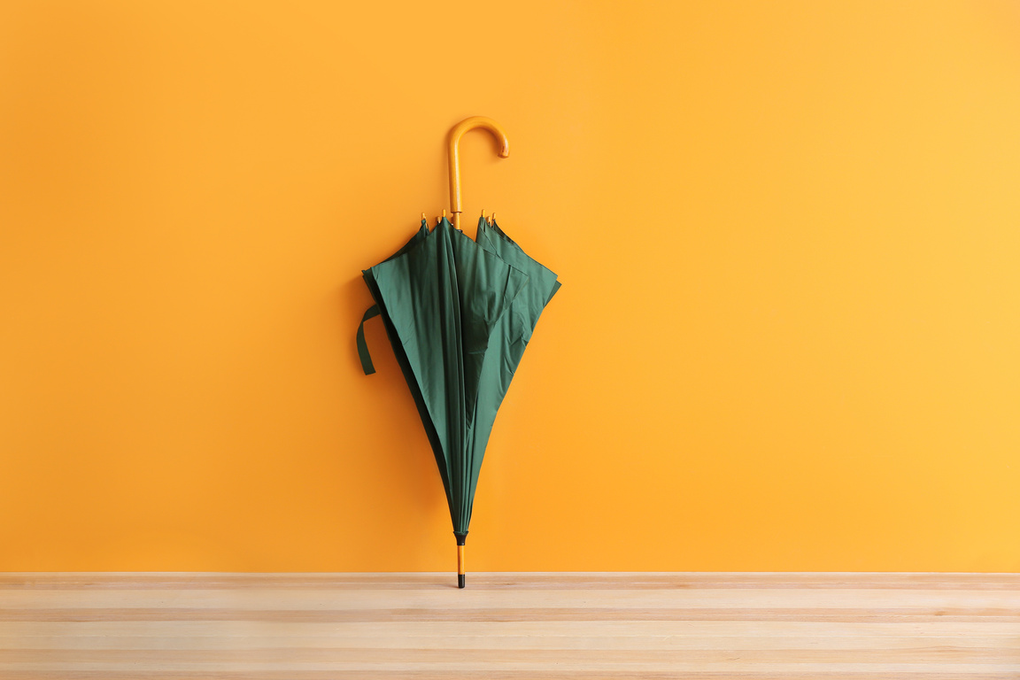 Stylish Umbrella on Color Background